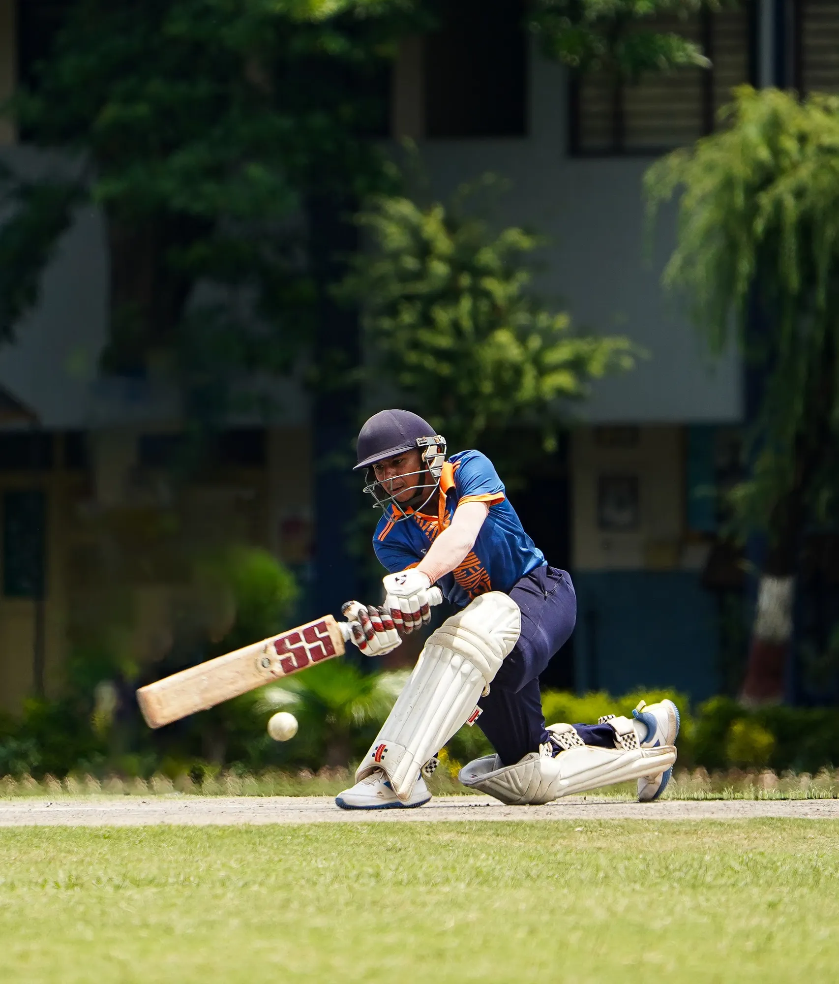 An SCA batter down on one knee playing the ball square
