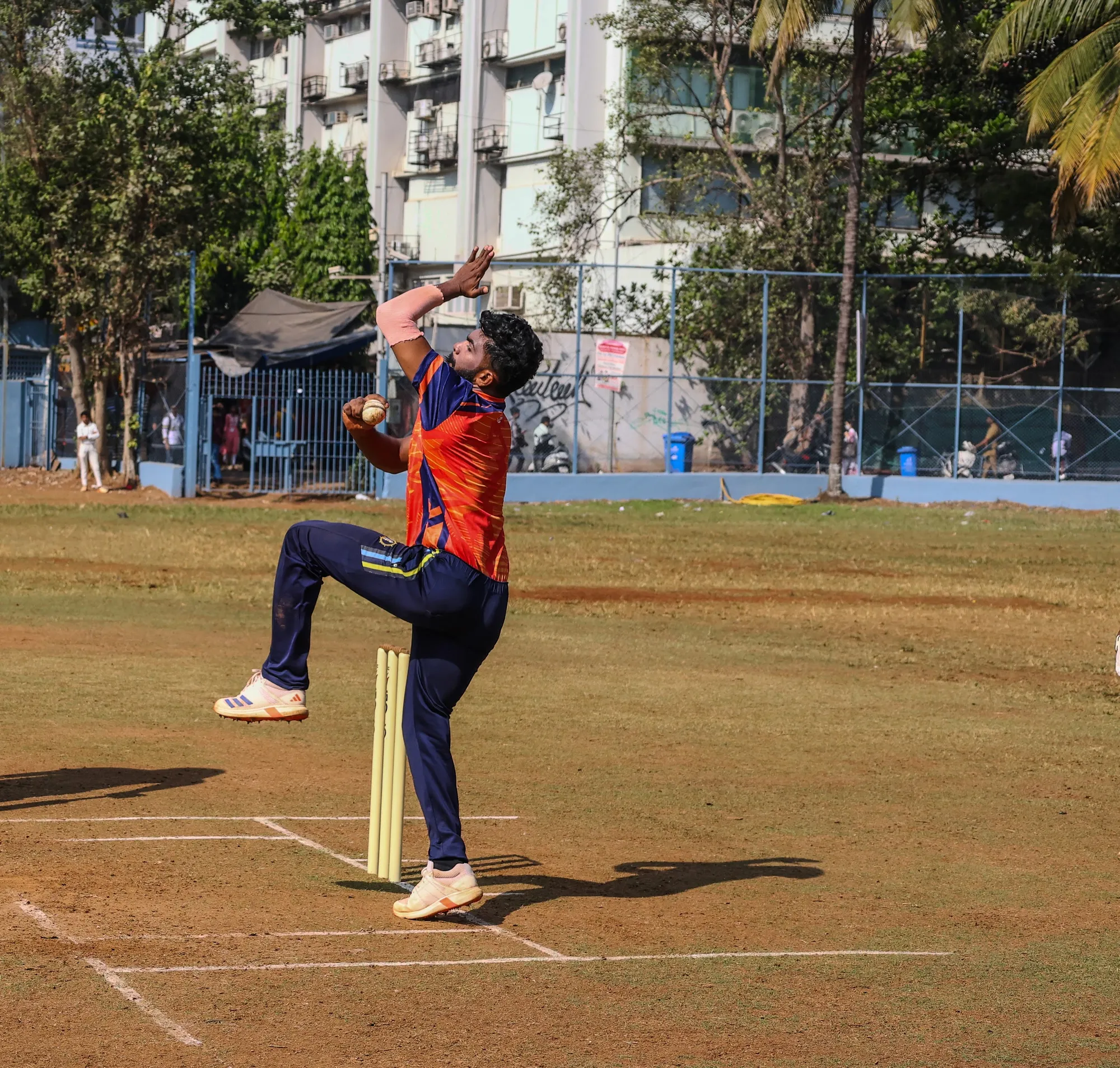 A bowler loading up at the crease, seen front on