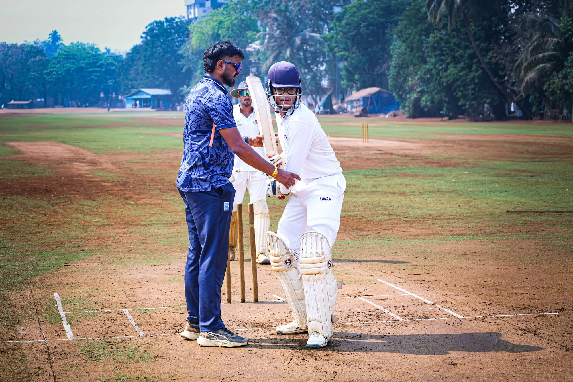 Coach Sunil Soni setting a young batter’s stance at the crease