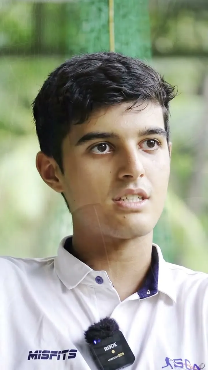 Arjun Gadoya in an SCA shirt, speaking to camera.