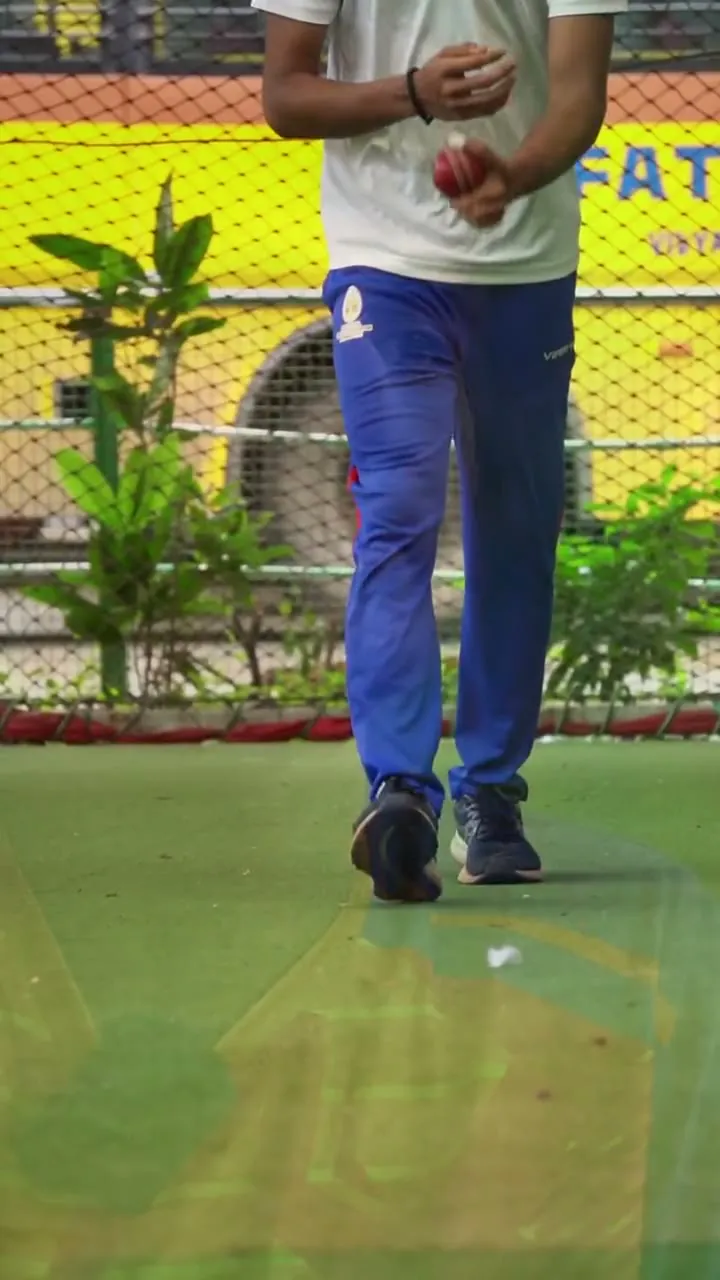 Nishit Balla in SCA match kit, seated in front of the practice nets.